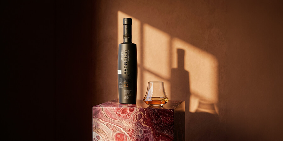 Octomore whisky and a glass, photographed in warm afternoon light
